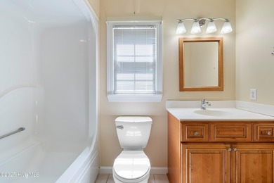 Experience coastal living in this charming 3-bedroom, 2-bath on Members Club At St. James Plantation in North Carolina - for sale on GolfHomes.com, golf home, golf lot