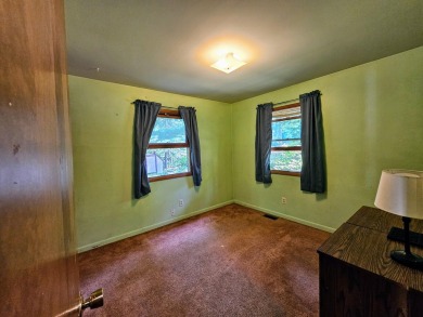This charming 3-bedroom, 1-bath chalet-style home offers a on Birch Pointe Golf Club in Michigan - for sale on GolfHomes.com, golf home, golf lot