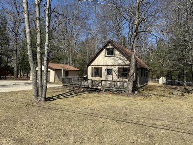 This charming 3-bedroom, 1-bath chalet-style home offers a on Birch Pointe Golf Club in Michigan - for sale on GolfHomes.com, golf home, golf lot
