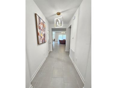 Built in 2024, this 4 bedroom / 3 bathroom Newcastle model on The Oasis Club at Champions Gate in Florida - for sale on GolfHomes.com, golf home, golf lot