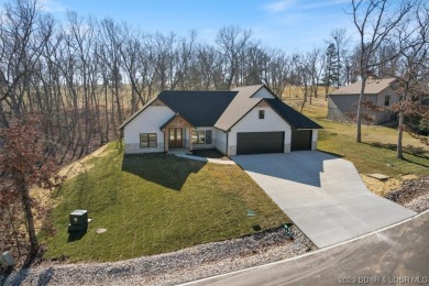 Discover the allure of this pristine, new construction on The Cove Course At the Lodge of the Four Seasons in Missouri - for sale on GolfHomes.com, golf home, golf lot