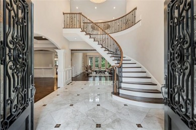 Positioned on a quiet cul-de-sac overlooking the 17th green on TPC At Sugarloaf Golf Club in Georgia - for sale on GolfHomes.com, golf home, golf lot