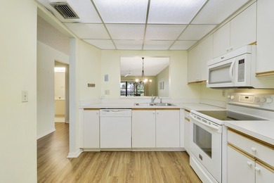 Enjoy panoramic golf and lake views from this 2 bedroom, 2 bath on  in Florida - for sale on GolfHomes.com, golf home, golf lot