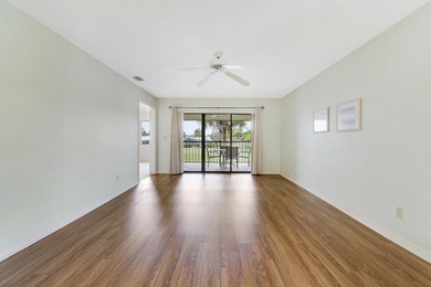 Enjoy panoramic golf and lake views from this 2 bedroom, 2 bath on  in Florida - for sale on GolfHomes.com, golf home, golf lot