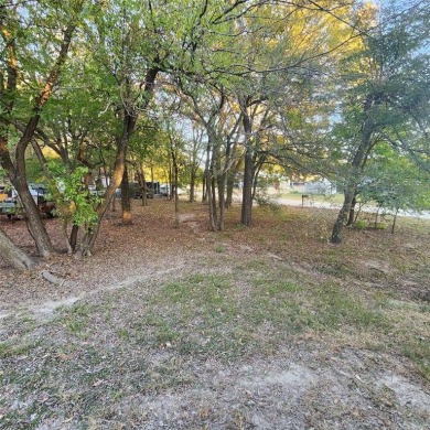 Wooded corner lot available in a lakefront community on Lake on Tawakoni Golf Course in Texas - for sale on GolfHomes.com, golf home, golf lot