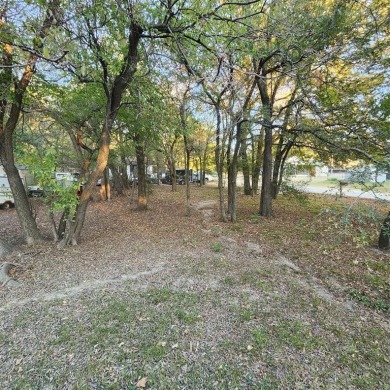 Wooded corner lot available in a lakefront community on Lake on Tawakoni Golf Course in Texas - for sale on GolfHomes.com, golf home, golf lot