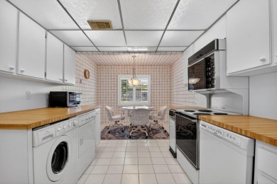 Elegant Country Club Living - Spacious 2-Bedroom + Den with Lake on Hunters Run Golf and Country Club in Florida - for sale on GolfHomes.com, golf home, golf lot