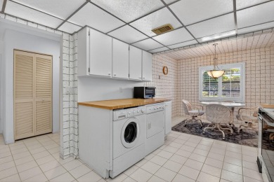 Elegant Country Club Living - Spacious 2-Bedroom + Den with Lake on Hunters Run Golf and Country Club in Florida - for sale on GolfHomes.com, golf home, golf lot