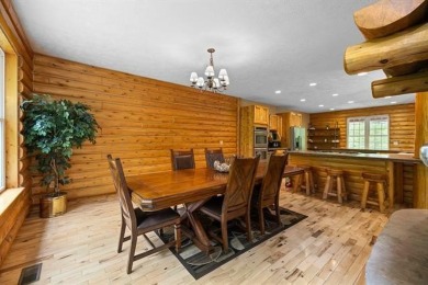 Stunning, custom-built log home overlooking the 16th tee & on Cedar River Golf Course in Michigan - for sale on GolfHomes.com, golf home, golf lot