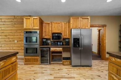 Stunning, custom-built log home overlooking the 16th tee & on Cedar River Golf Course in Michigan - for sale on GolfHomes.com, golf home, golf lot