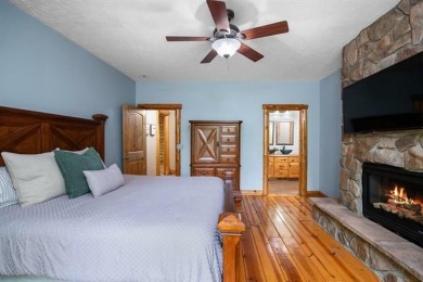 Stunning, custom-built log home overlooking the 16th tee & on Cedar River Golf Course in Michigan - for sale on GolfHomes.com, golf home, golf lot
