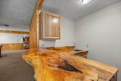 Stunning, custom-built log home overlooking the 16th tee & on Cedar River Golf Course in Michigan - for sale on GolfHomes.com, golf home, golf lot