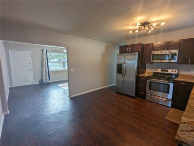 This beautifully maintained three-bedroom, two-bathroom home on The Dunedin Country Club in Florida - for sale on GolfHomes.com, golf home, golf lot