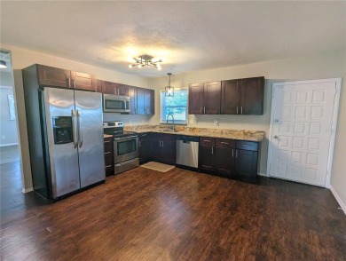 This beautifully maintained three-bedroom, two-bathroom home on The Dunedin Country Club in Florida - for sale on GolfHomes.com, golf home, golf lot