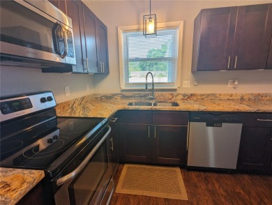This beautifully maintained three-bedroom, two-bathroom home on The Dunedin Country Club in Florida - for sale on GolfHomes.com, golf home, golf lot