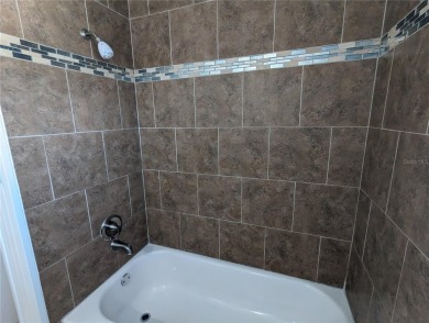 This beautifully maintained three-bedroom, two-bathroom home on The Dunedin Country Club in Florida - for sale on GolfHomes.com, golf home, golf lot