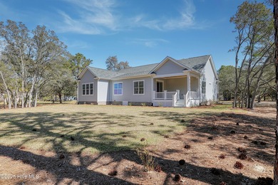 Cradled by the gentle currents where the Shallotte River meets on Lockwood Folly Country Club in North Carolina - for sale on GolfHomes.com, golf home, golf lot