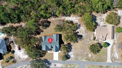 Cradled by the gentle currents where the Shallotte River meets on Lockwood Folly Country Club in North Carolina - for sale on GolfHomes.com, golf home, golf lot