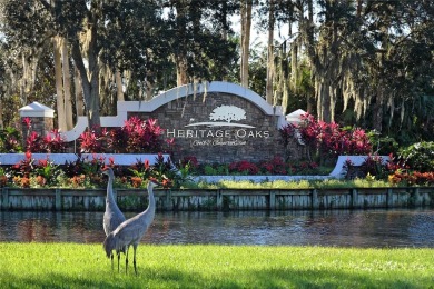 Nestled in the private community of Heritage Oaks Golf & Country on Heritage Oaks Golf and Country Club in Florida - for sale on GolfHomes.com, golf home, golf lot