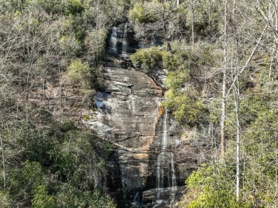 This 1 acre lot while gently sloping, overlooks the 17th green on Lake Toxaway Country Club in North Carolina - for sale on GolfHomes.com, golf home, golf lot