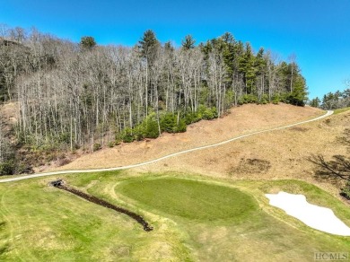 This 1 acre lot while gently sloping, overlooks the 17th green on Lake Toxaway Country Club in North Carolina - for sale on GolfHomes.com, golf home, golf lot