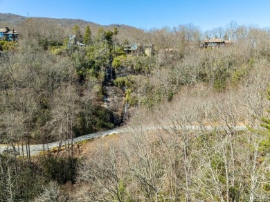 This 1 acre lot while gently sloping, overlooks the 17th green on Lake Toxaway Country Club in North Carolina - for sale on GolfHomes.com, golf home, golf lot