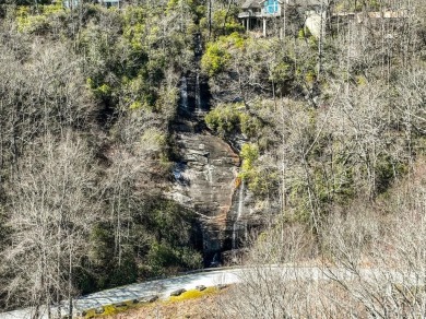This 1 acre lot while gently sloping, overlooks the 17th green on Lake Toxaway Country Club in North Carolina - for sale on GolfHomes.com, golf home, golf lot
