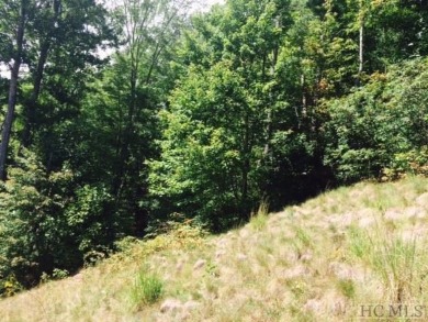 This 1 acre lot while gently sloping, overlooks the 17th green on Lake Toxaway Country Club in North Carolina - for sale on GolfHomes.com, golf home, golf lot