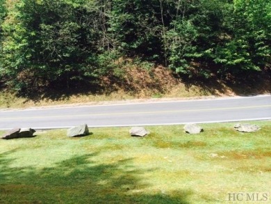 This 1 acre lot while gently sloping, overlooks the 17th green on Lake Toxaway Country Club in North Carolina - for sale on GolfHomes.com, golf home, golf lot