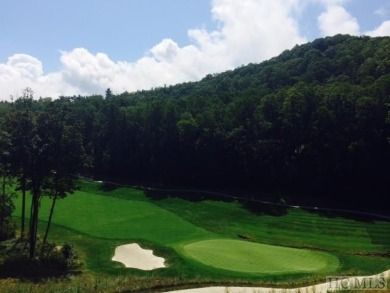 This 1 acre lot while gently sloping, overlooks the 17th green on Lake Toxaway Country Club in North Carolina - for sale on GolfHomes.com, golf home, golf lot