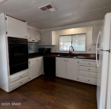 Check out this 2 bedroom, 1 bath home nestled in the tall pines on Bison Golf and Country Club in Arizona - for sale on GolfHomes.com, golf home, golf lot