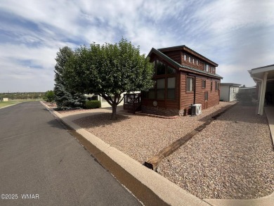 Get a cozy cabin feel in this charming home in desirable Juniper on Juniper Ridge R.V. Golf Resort in Arizona - for sale on GolfHomes.com, golf home, golf lot