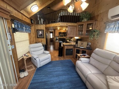 Get a cozy cabin feel in this charming home in desirable Juniper on Juniper Ridge R.V. Golf Resort in Arizona - for sale on GolfHomes.com, golf home, golf lot