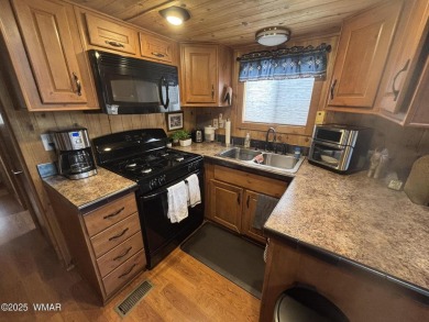 Get a cozy cabin feel in this charming home in desirable Juniper on Juniper Ridge R.V. Golf Resort in Arizona - for sale on GolfHomes.com, golf home, golf lot