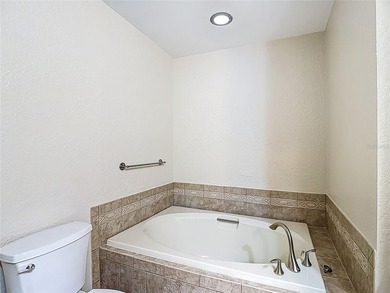 Palm Harbor - Nestled in the gated community of Wescott Square on Tarpon Woods Golf Club in Florida - for sale on GolfHomes.com, golf home, golf lot