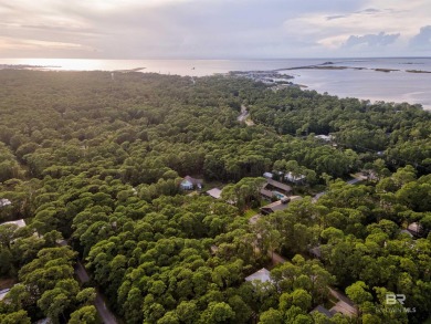 Fall in love with this cozy three bedroom, two bath home tucked on Isle Dauphine Club Golf Course in Alabama - for sale on GolfHomes.com, golf home, golf lot