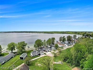 Welcome to 1171 North Shore, an exceptional waterfront property on Duck Lake Country Club in Michigan - for sale on GolfHomes.com, golf home, golf lot