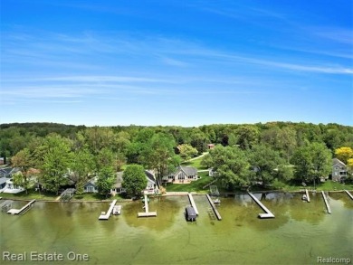 Welcome to 1171 North Shore, an exceptional waterfront property on Duck Lake Country Club in Michigan - for sale on GolfHomes.com, golf home, golf lot
