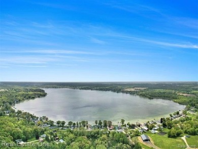 Welcome to 1171 North Shore, an exceptional waterfront property on Duck Lake Country Club in Michigan - for sale on GolfHomes.com, golf home, golf lot