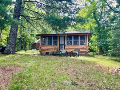 Step back in time with this charming, 100+ year-old seasonal log on Minnesota National Golf Course in Minnesota - for sale on GolfHomes.com, golf home, golf lot