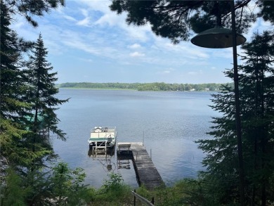 Step back in time with this charming, 100+ year-old seasonal log on Minnesota National Golf Course in Minnesota - for sale on GolfHomes.com, golf home, golf lot