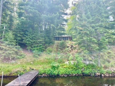Step back in time with this charming, 100+ year-old seasonal log on Minnesota National Golf Course in Minnesota - for sale on GolfHomes.com, golf home, golf lot