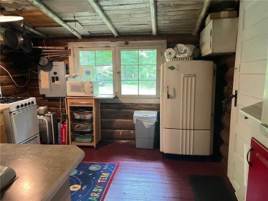 Step back in time with this charming, 100+ year-old seasonal log on Minnesota National Golf Course in Minnesota - for sale on GolfHomes.com, golf home, golf lot