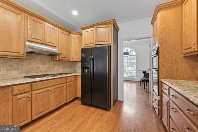 Step inside to find gleaming hardwood floors throughout the main on Chapel Hills Golf and Country Club in Georgia - for sale on GolfHomes.com, golf home, golf lot