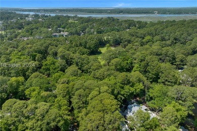 Nestled amidst stunning landscapes adorned with majestic trees on Long Cove Club in South Carolina - for sale on GolfHomes.com, golf home, golf lot