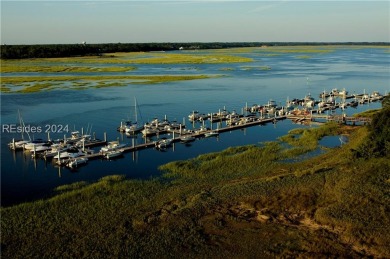 Nestled amidst stunning landscapes adorned with majestic trees on Long Cove Club in South Carolina - for sale on GolfHomes.com, golf home, golf lot