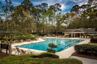 Nestled amidst stunning landscapes adorned with majestic trees on Long Cove Club in South Carolina - for sale on GolfHomes.com, golf home, golf lot