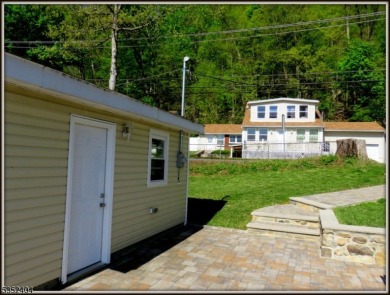 Completely renovated in 2020 this year round home sits on the on Lake Lackawanna Golf Course in New Jersey - for sale on GolfHomes.com, golf home, golf lot