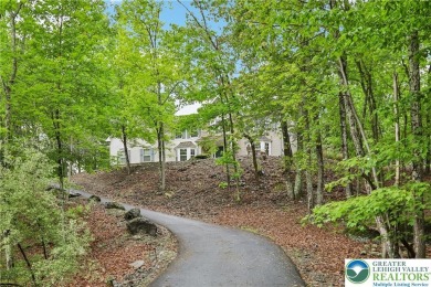 Perched atop a scenic hilltop, 136 Outlook Court offers a unique on Country Club of the Poconos Golf Course in Pennsylvania - for sale on GolfHomes.com, golf home, golf lot