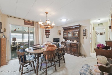 This 2 bedroom, 2 bath home with a covered carport wraps you in on High Point Golf Club, Inc. in Florida - for sale on GolfHomes.com, golf home, golf lot